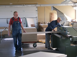 Photo of assistant and Randy working in the shop